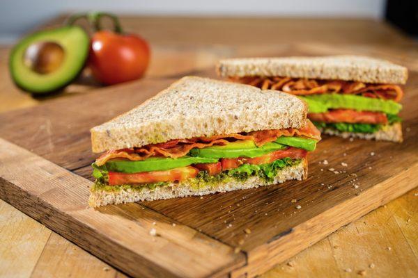 AVOCADO BLT: crispy bacon, lettuce, tomato, sliced avocado and kale pesto spread.