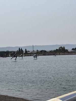 The view from the bank- sit on the grass and relax. Watch the fun or join in! The lake is calm with enough wind to sail - windsurf.