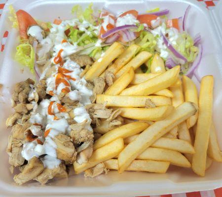 The chopped chicken breast with special traditional spice used+ French Fried and homemade salat mix(lettuce, onion, tomato with Tzatziki