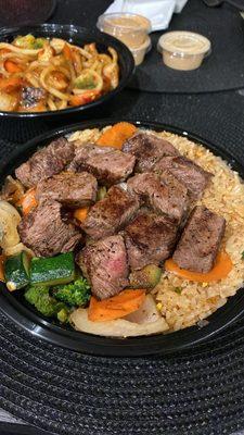 Steak bowl with rice & veggies. Spicy Yakisoba noodles with chicken in the back