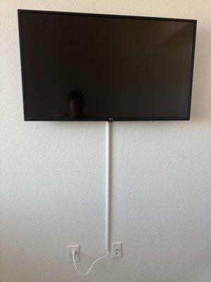 Tv Mounted with concealed wire since we couldn't add an outlet behind TV. Looks great!