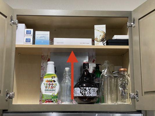 Cabinet shelf with notch cutout since range vent duct would've otherwise made it impossible for a top shelf to be placed there.