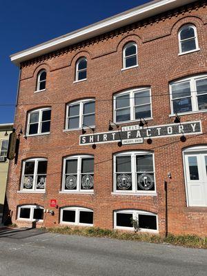 Great reuse of a shirt factory!  Has a pub serving Collusion Tapworks beers and a floor for music events and other parties.