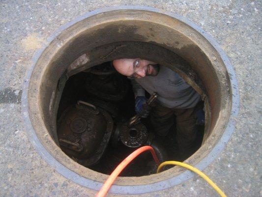 One of our technicians preparing a valve for a replacement in a manhole!