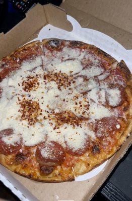 Pepperoni pizza with lots and lots of Parmesan and pepper flakes.