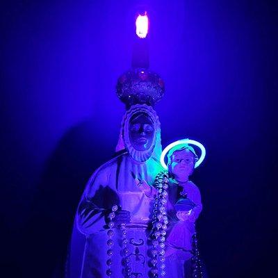 Blacklight Jesus and Mary stand ready to absolve your sins...