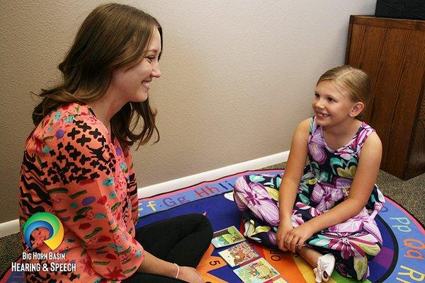 A speech therapist works with a young girl in Cody, WY.