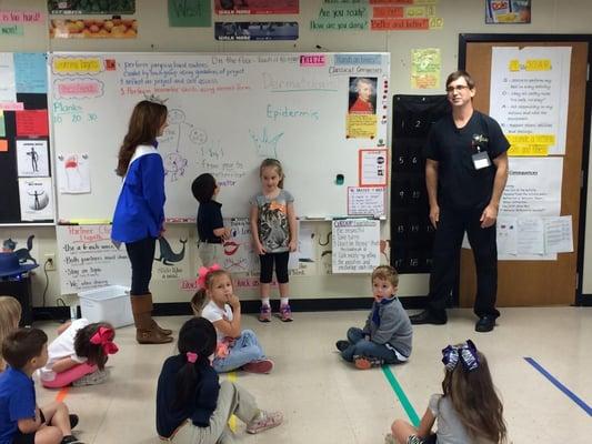 Community outreach is important.  Dr Massengale at a local elementary school teaching the importance of sun protection.