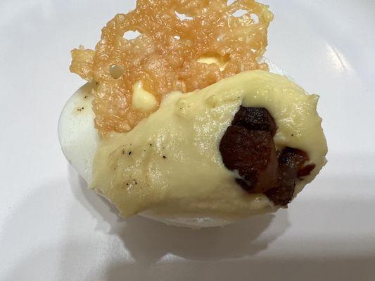 Deviled egg with Parmesan and pork belly