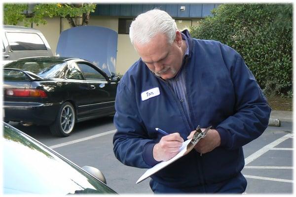 Tom Smith inspecting serviced vehicle.