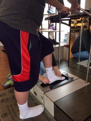 Getting his foot measured for his custom insoles.