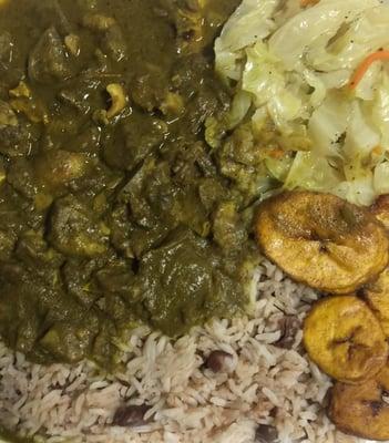 Curry Goat with rice and peas, plantains,and cabbage.