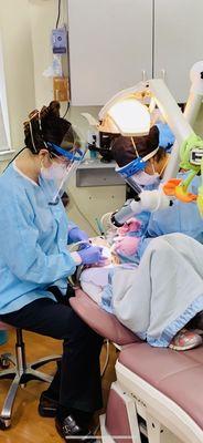 Doing fillings safely with all PPE and extra oral suction.