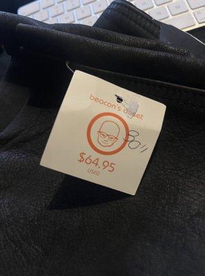 the $65 price tag with a size 30 written on it