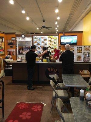 The owner takes the time to explain the dishes to customers.