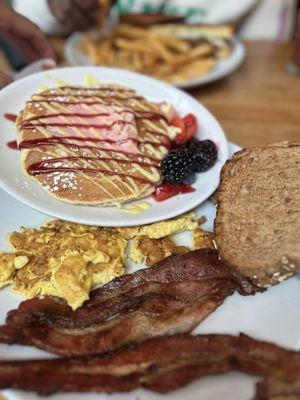 Two eggs with  "Signature Berry Bliss" Pancakes