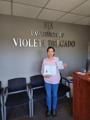 My wife with her Naturalizarion certificate and green card that ms. Delgado got approved for her!