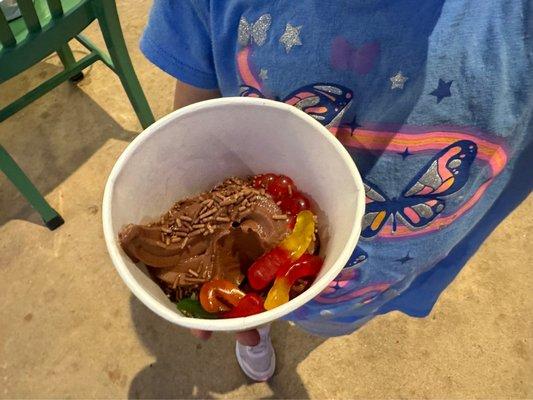 Chocolate frozen yogurt with chocolate sprinkles, gummy worms, and strawberry bursters