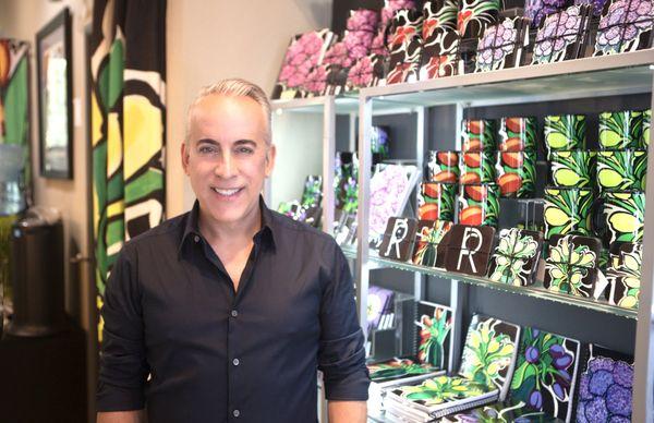 Salon Owner Romi Cortier with his exclusive Artful Living Housewares line, inspired by his original fine art, all available at the Salon.