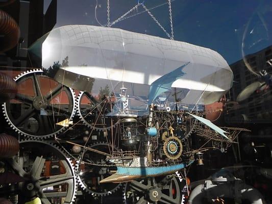 Mechanical airship in the front window. During business hours, the wheel turns, the wings flap, and the place on the back moves