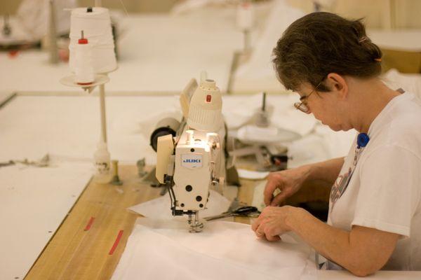 One of our tailors in Mason, Ohio plant working on sewing a pillowcase.