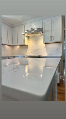 Quartz counters and full height backsplash.