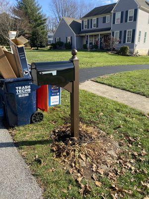 New mailbox post cemented into ground.