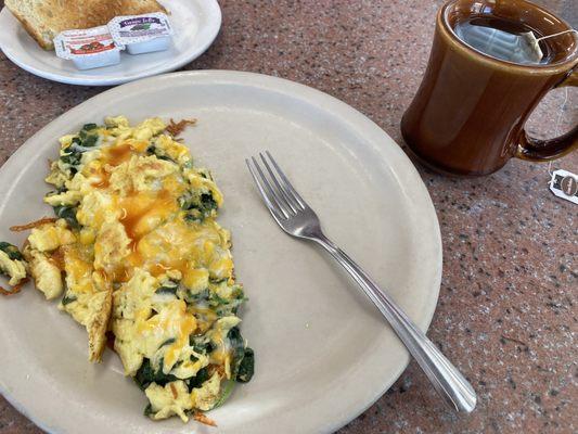 Breakfast spinach scramble full of yumminess and a mug of tea