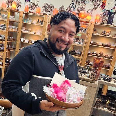 Alex in front of the crystals at the shop. He's also holding our monthly Soul Synch kit. The theme changes monthly to help with your energy