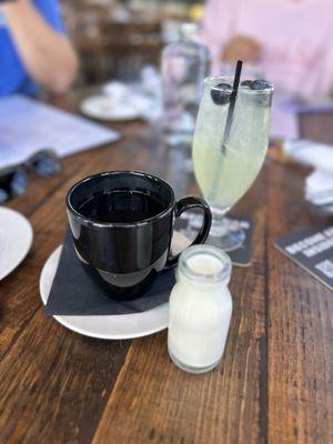 Coffee with a cute bottle of cream and Berry Lemonade