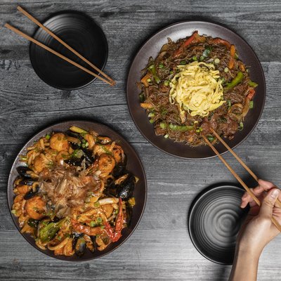 Bulgogi japchae and stir fried spicy seafood udon