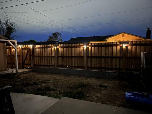 Cedar Board-on Board fence with steel posts atop a new concrete short wall.