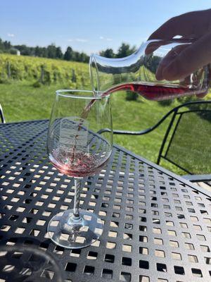 Pouring wine from a flight on a beautiful day