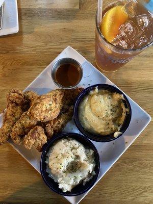 Fried Chicken Tenders, side of the Nashville hot sauce, Mashed Potatoes, and Grits.