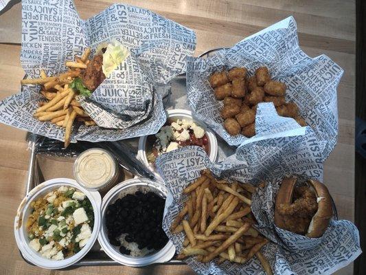 Chicken pimento crunch wrapped in lettuce. Crispy chicken sandwich. Tots, chili corn, cucumber feta salad, black beans and rice.