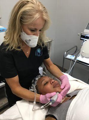 Medical Aesthetician, Laura Carpenter, gives one of our beautiful clients a Hydrafacial.