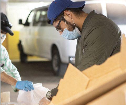 Every other Friday, families drive through our garage for groceries & pre-made meals.