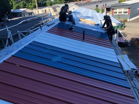 Tri-color roof installation in process.