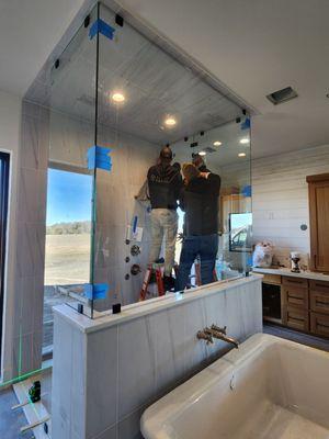 Installing a large shower enclosure.