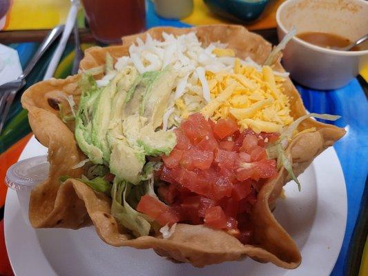 Yummy taco salad with beef and a generous heap of toppings.