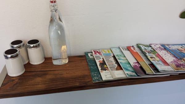 Magazines a bottle water with glasses really nice so you can drink water if you get thirsty