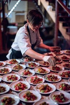 Final touches on a fresh tomato salad...