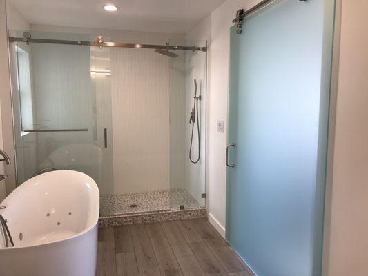 Master bath, shower enclosure and custom made sliding glass barn door.