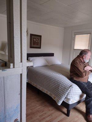 The main bed, tv to the right, front door