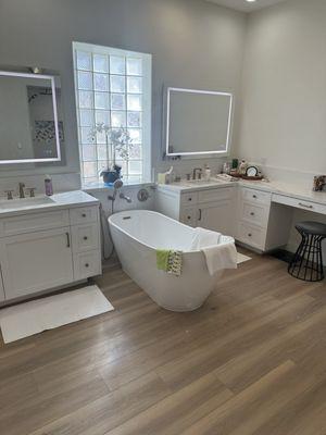 Introducing the newly remodeled bathroom, adorned with the captivating Lone Star Spirit XL Artisan Touch 100% Waterproof Vinyl Plank