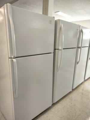 Row of refrigerator-freezers ready for sale and delivery - minus the one on the end!