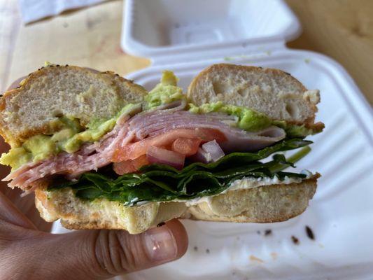 Ham everything bagel with cream cheese, tomato, spinach, red onion, and avocado.