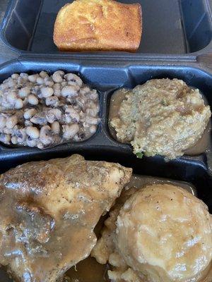 Smothered chicken, mashed potatoes, cornbread dressing, peas, cornbread