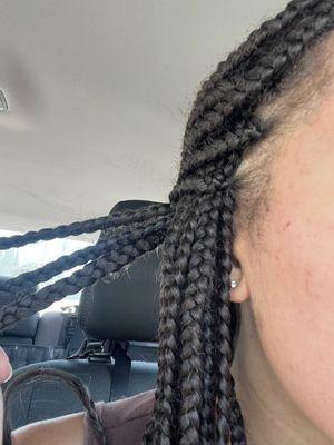 Some hair coming out of the braids