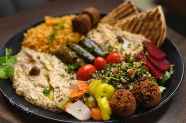 Mediterranean Platter- Hummus, Baba Ghanoush, Grape Leaves, Tabuli Salad, Grilled Vegetables & Falafel.